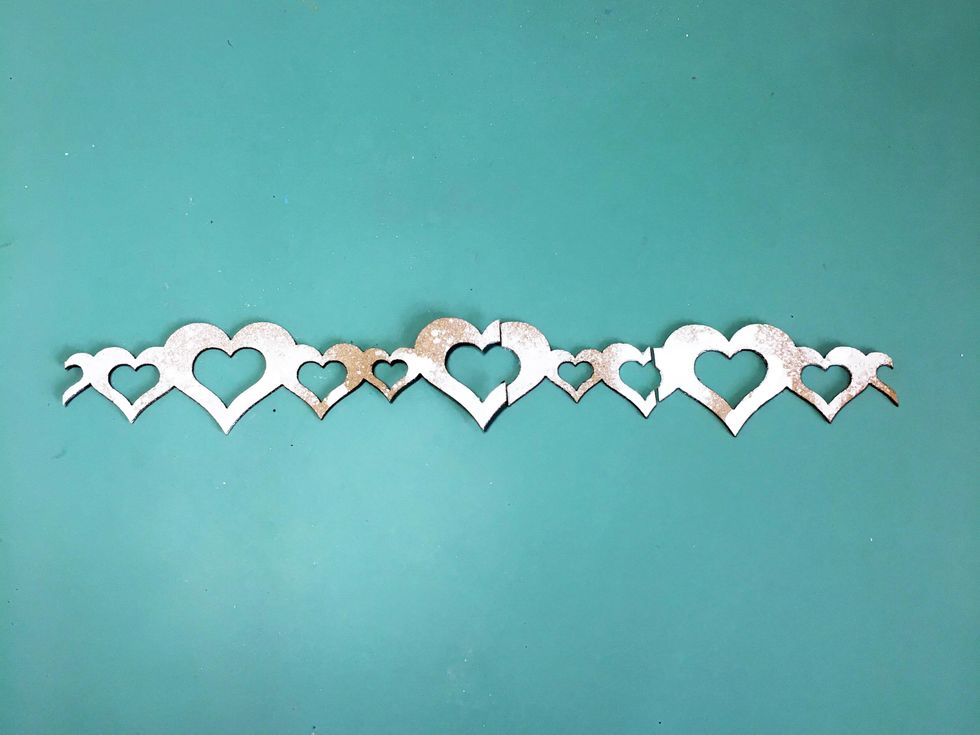 Spray the heart border with white mist. Cut it apart so that you can fit it under your photo.
