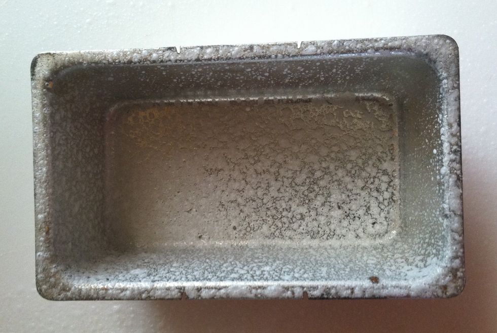 Spray the loaf pan or butter and then flour it.  Knock the pan against the counter to remove excess flour.