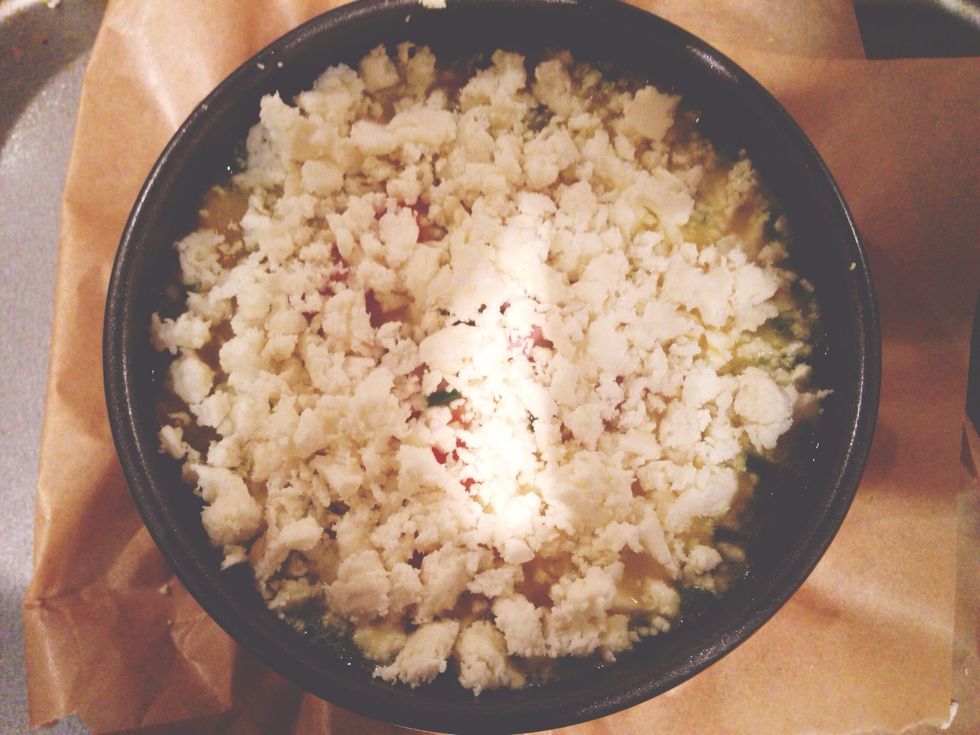 Spray the tin with fry light butter. Pour the mix in the tin and add crumbled feta on top