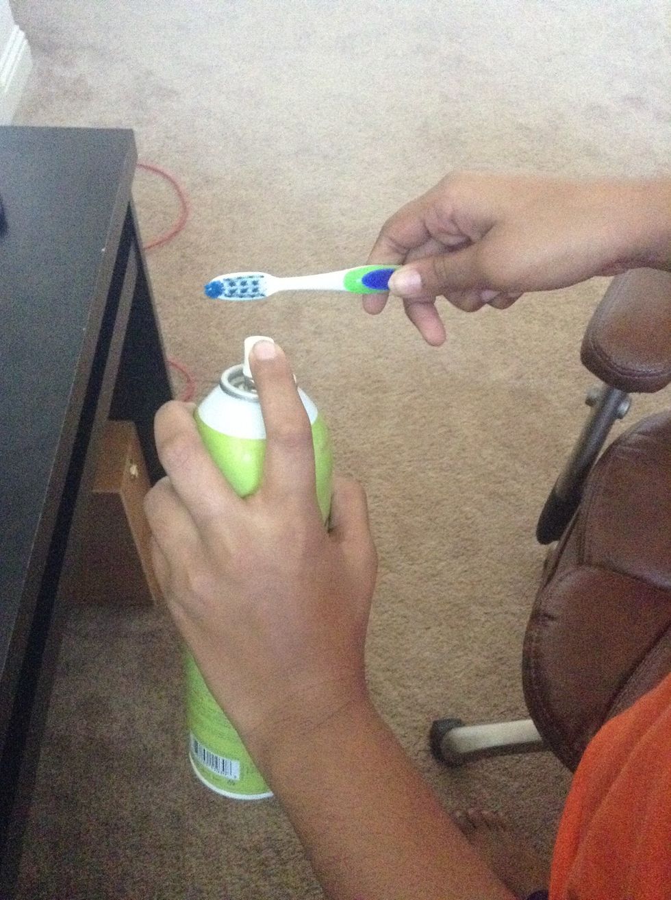 Spray the toothbrush with your hairspray.