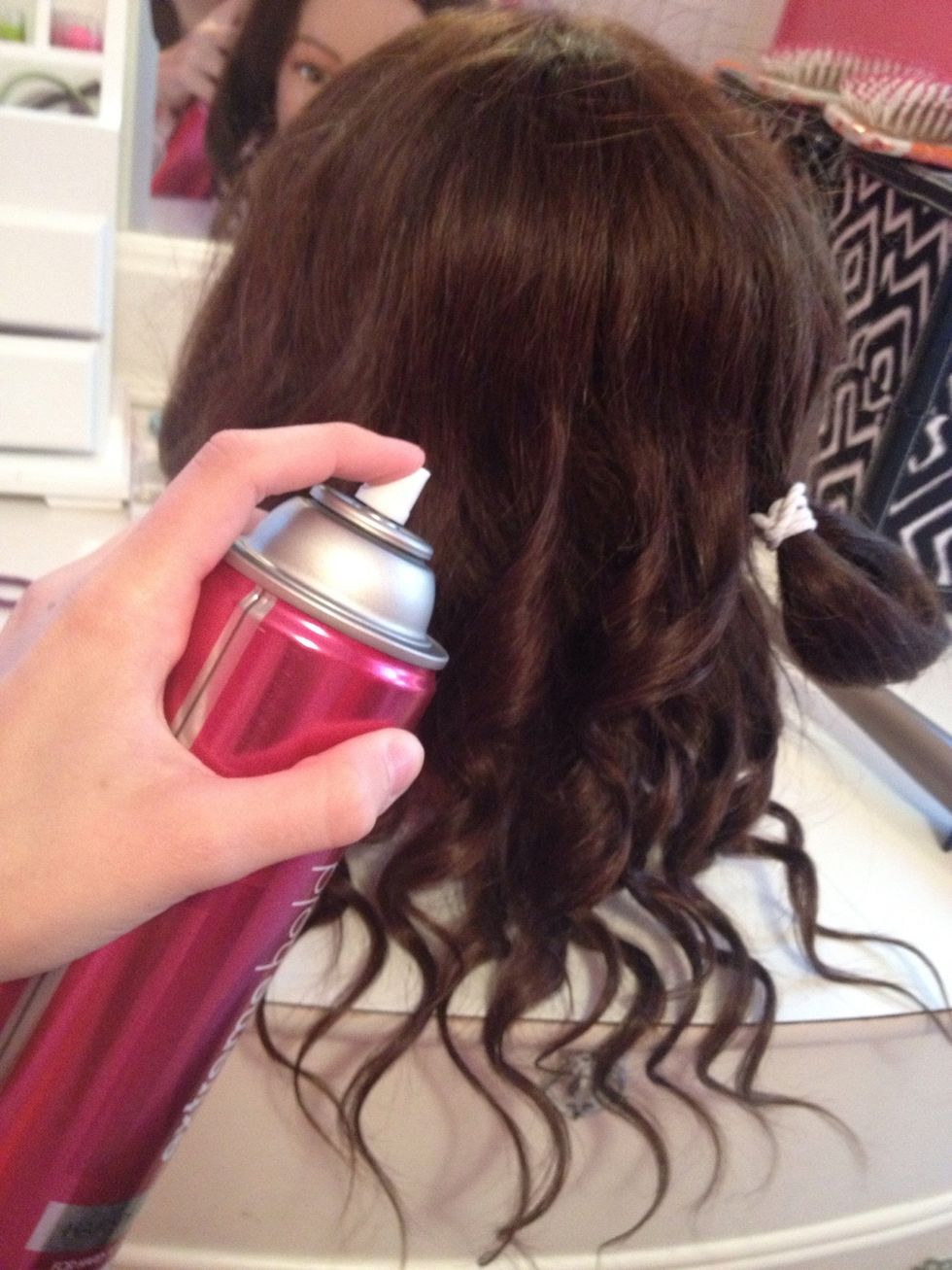 Spray the top section you just finished curling. Be careful not to spray the tied section.