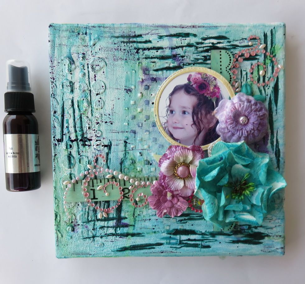 Spray Timeless Colorations over the page. Add all flowers, rhinestones, photo, wooden piece over the page as shown.