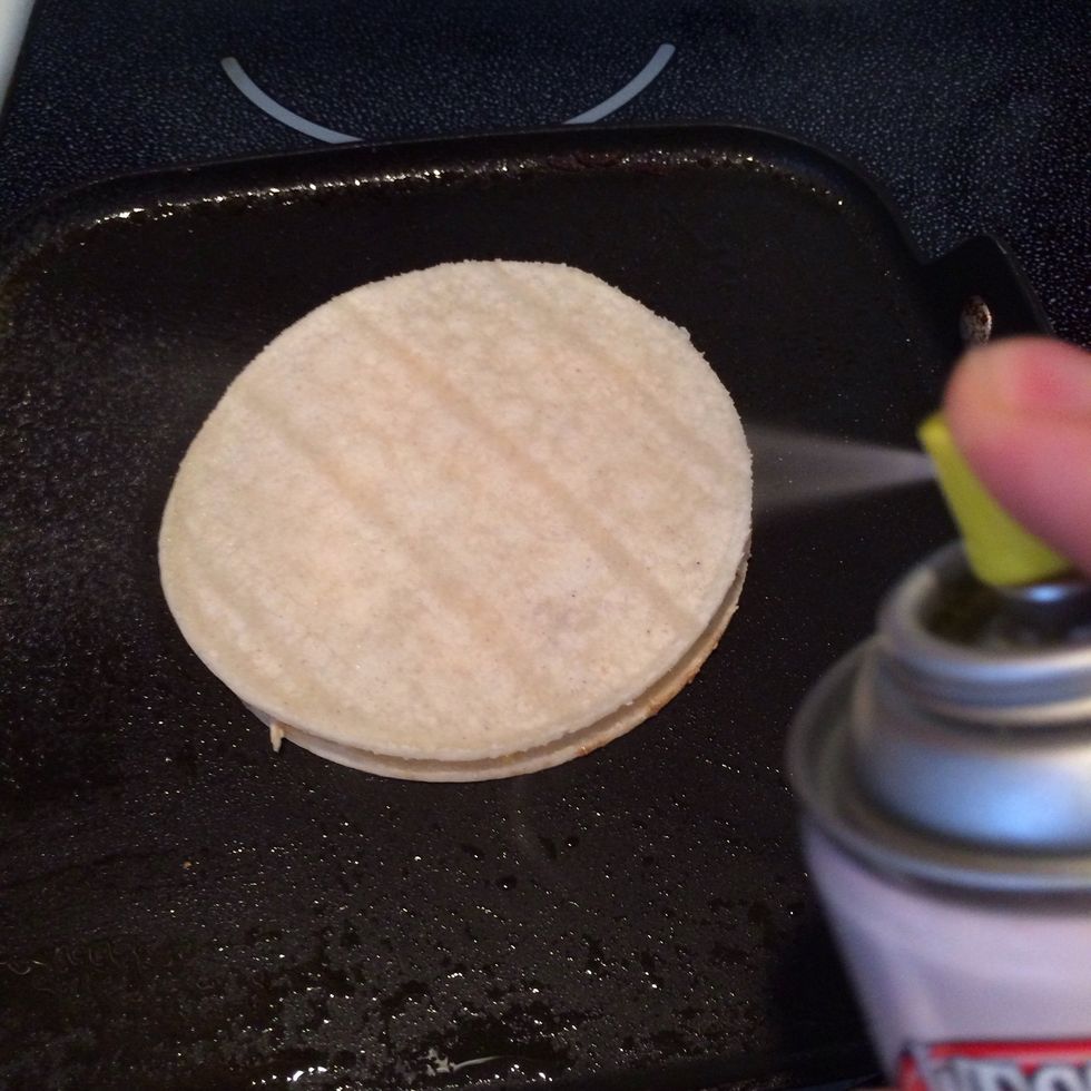 Spray tortilla with canola cooking spray.
