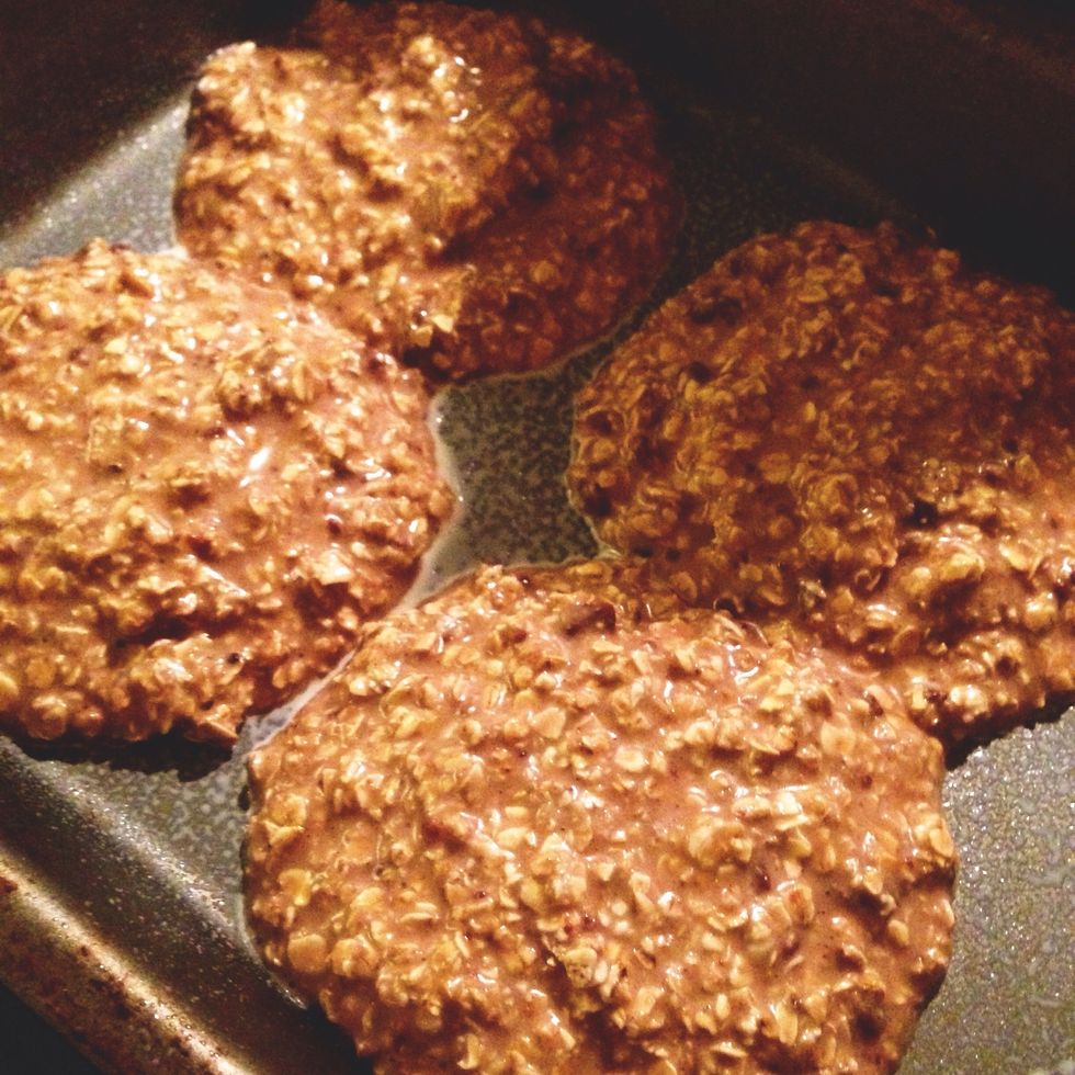 Spray tray with fry light. Put the mix in the baking tray (makes 4 big cookies, or you can make them smaller)