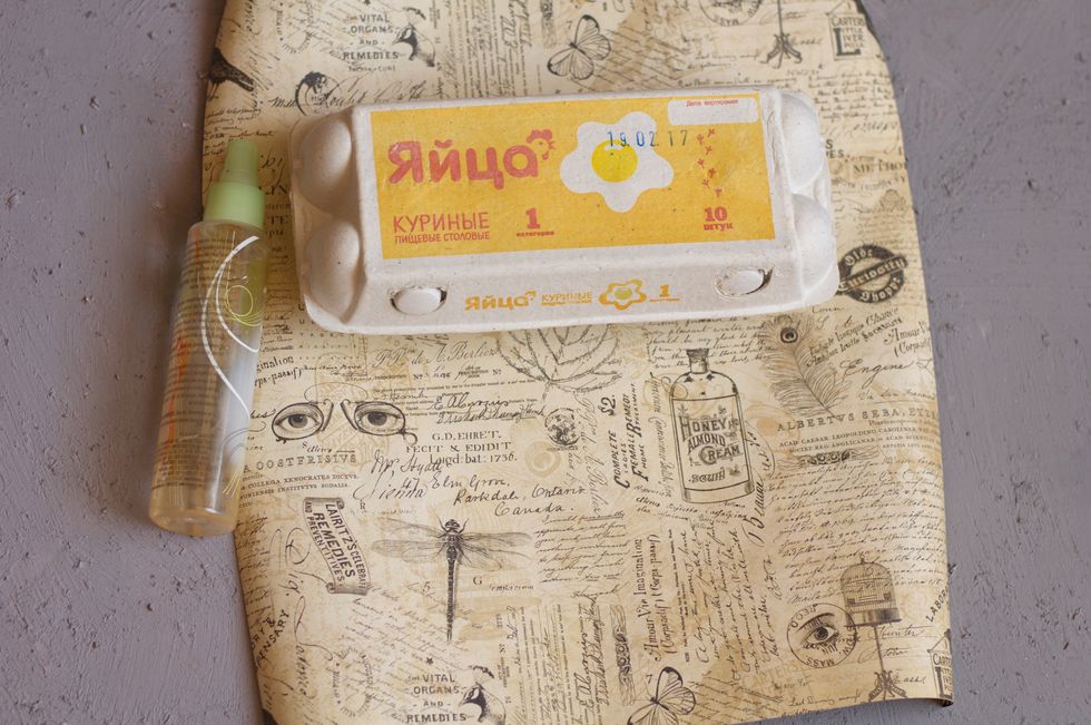 Spray water onto paper, so it became softer, it's easier to stick it on the box.