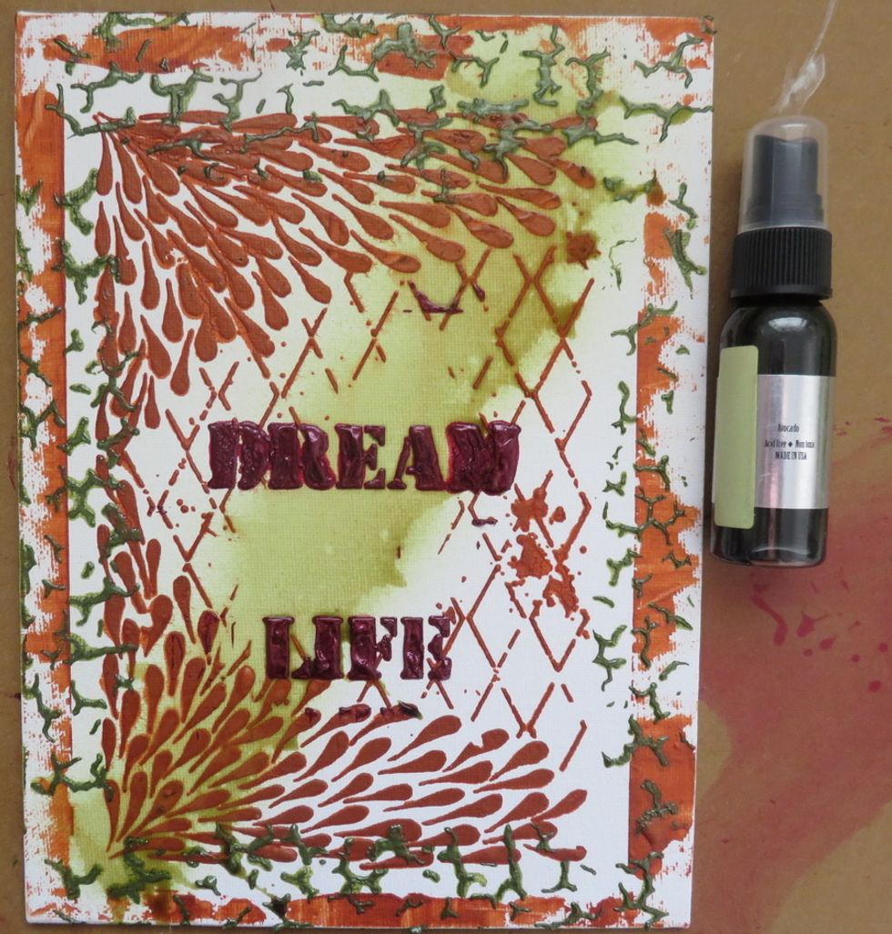 Spray with Avocado Colorations spray in the middle of the canvas.