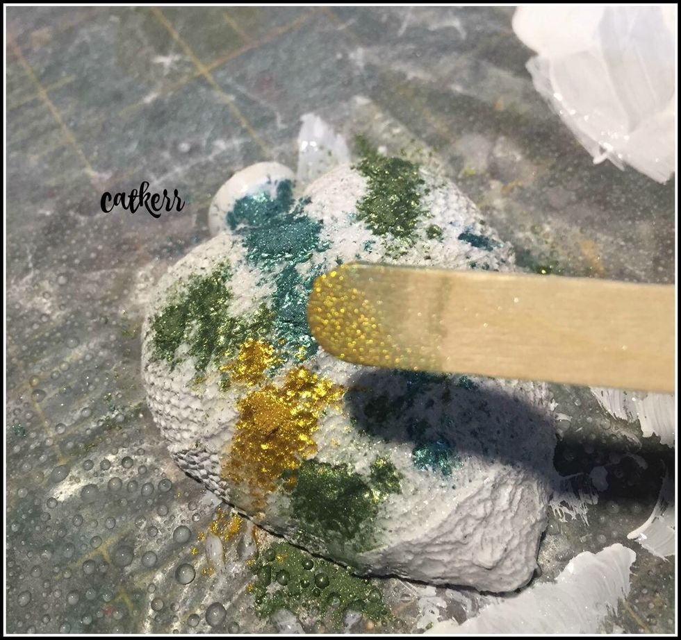 Spray with water then sprinkle on assorted colors of Alumidust and  spread around with a brush until you reach desired color