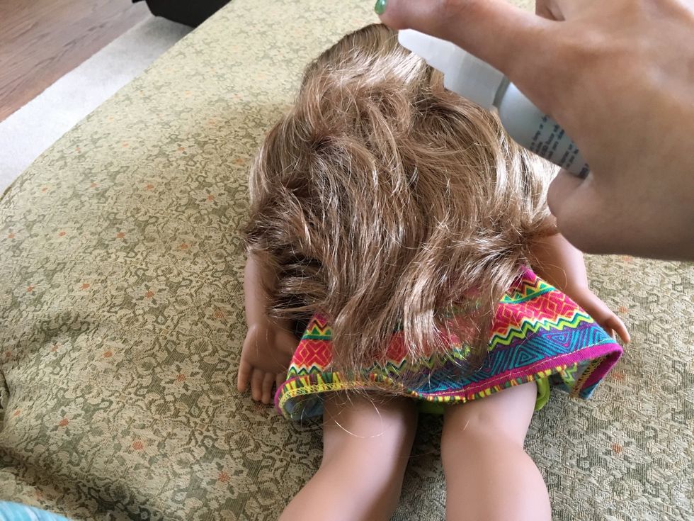 Spray your doll\u2019s hair with water
