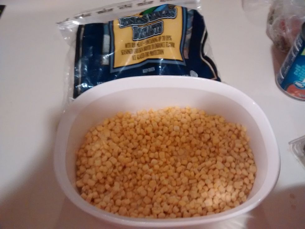 Spray your oven proof dish with cooking spray. Next, pour the frozen corn into the dish and cook your chicken. Once it is done cooking, place the chicken in the dish with the corn.