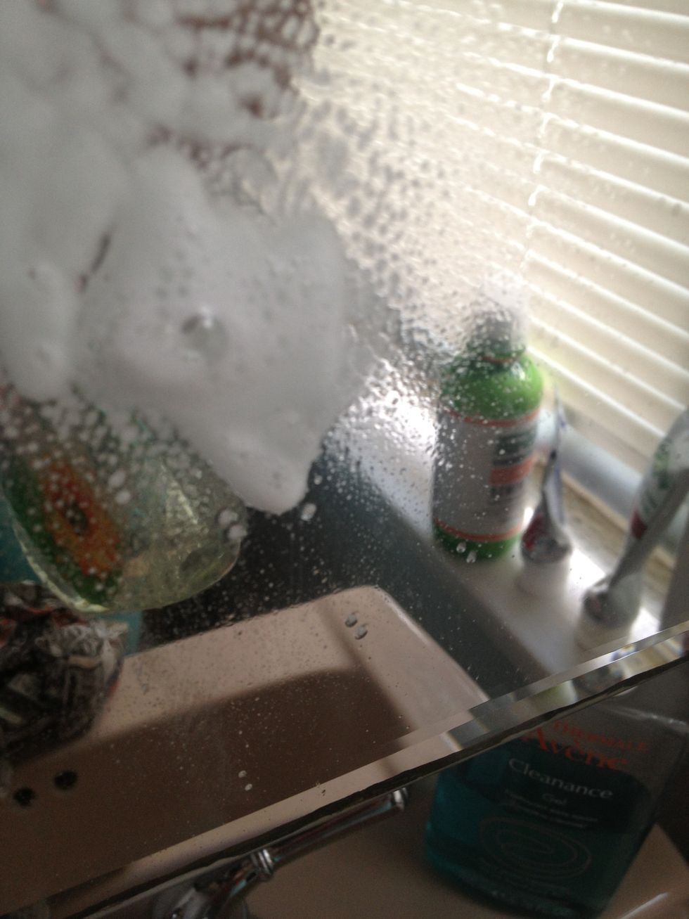 Spray your window cleaner on the dirty mirror. My bathroom mirror is gross on a daily basis because of the toothpaste stains, so I clean it regularly.