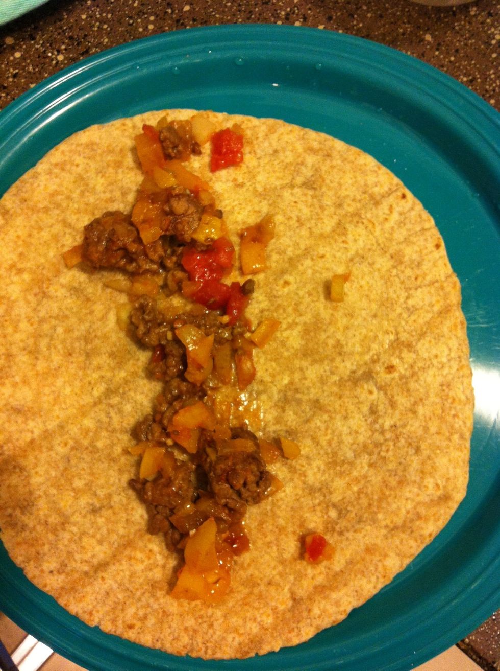 Spread 1/3 of your mixture onto one of the tortillas and roll it up, do this with the other two as well.