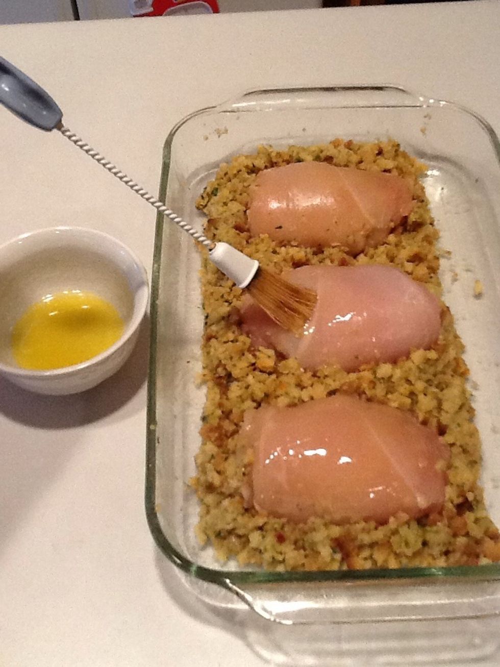 Spread 2 tbsp. butter on top of chicken breasts. Place in the oven and bake for 30-35 minutes.