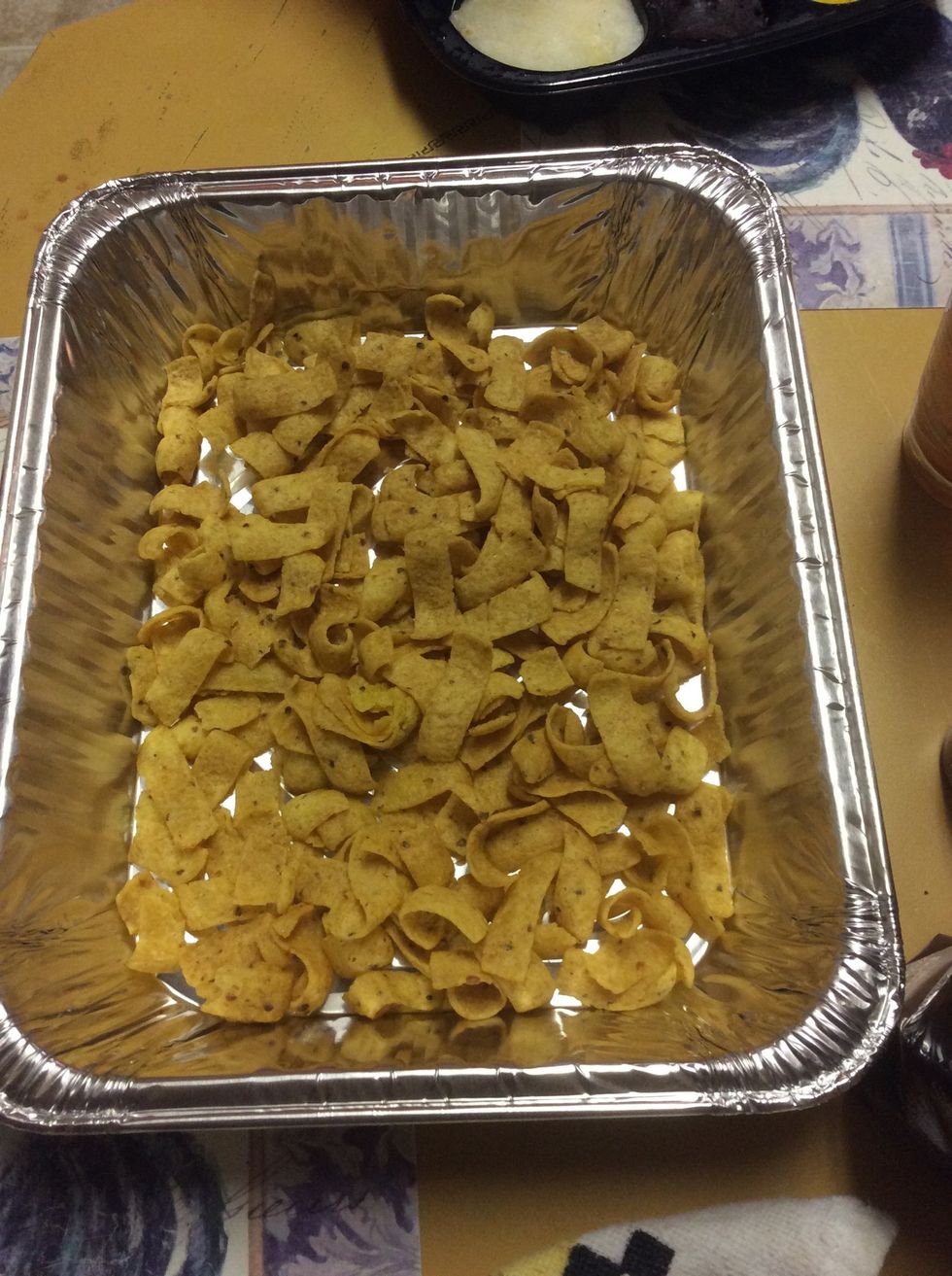Spread 3 cups of Fritos in a baking dish (9x13)