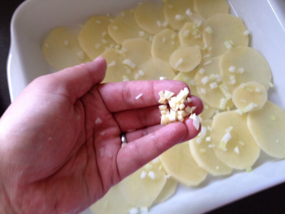 Spread a bit of chopped garlic over the potatoes.