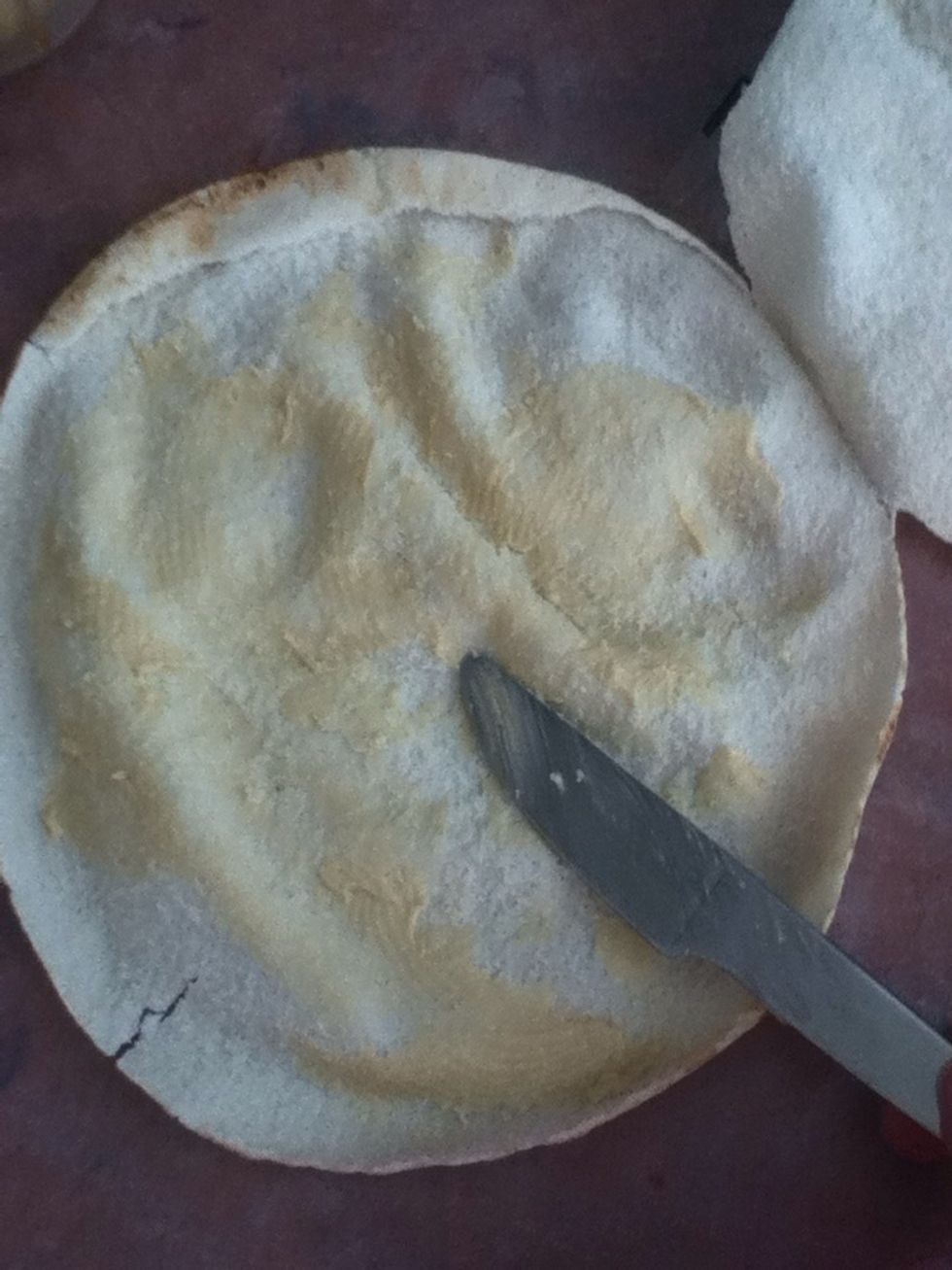 Spread a little bit of hummus on the pita bread ( this is the second sauce )