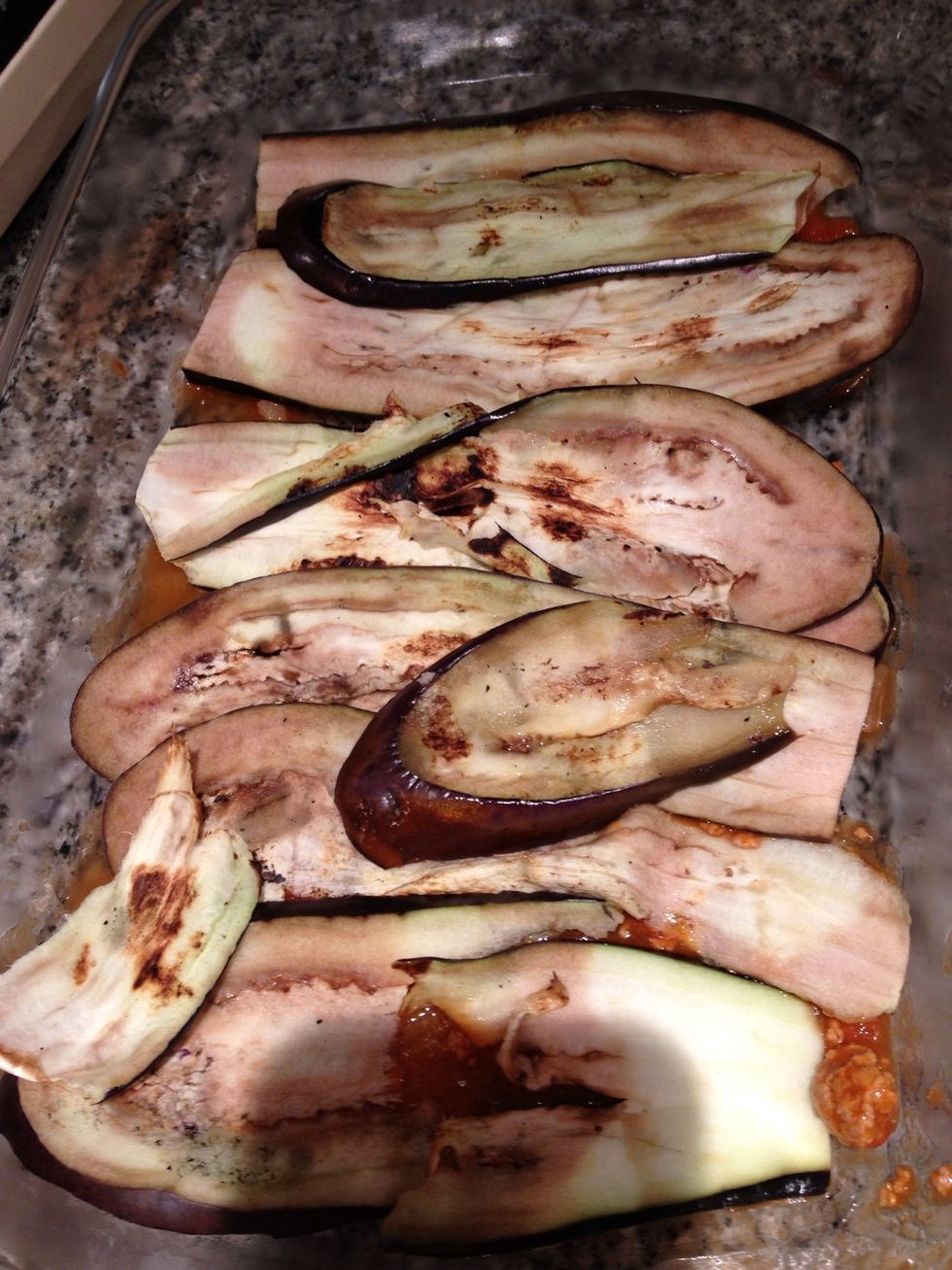 Spread a little of the tomato sauce and put the eggplants in a oven proof dish