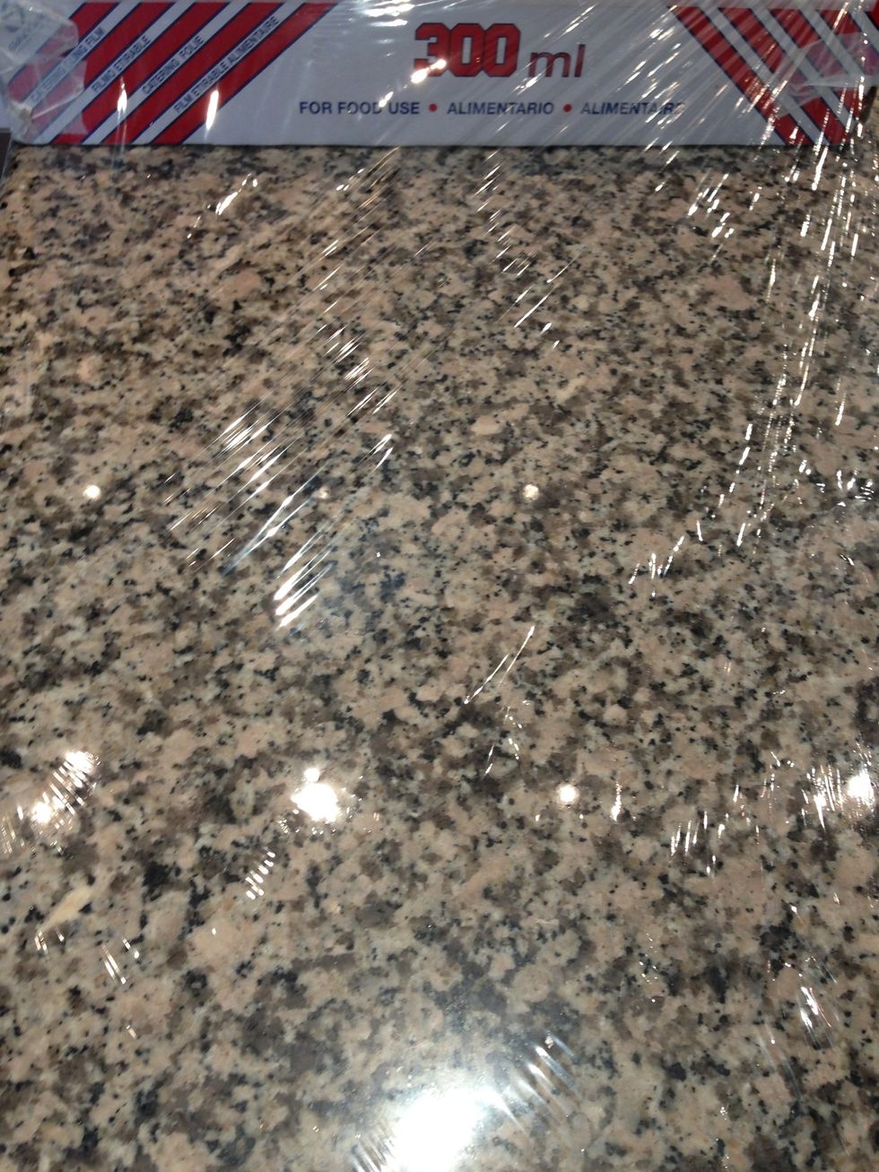 Spread a sheet of cling film . It sticks best on stone or granite surface. .. If your cling film is not wide enough use another layer crosswise. And if you don't have this surface the...