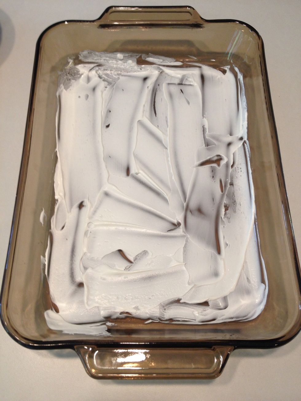 Spread a small amount of whipped cream in the bottom of a 11 x 14 baking dish.