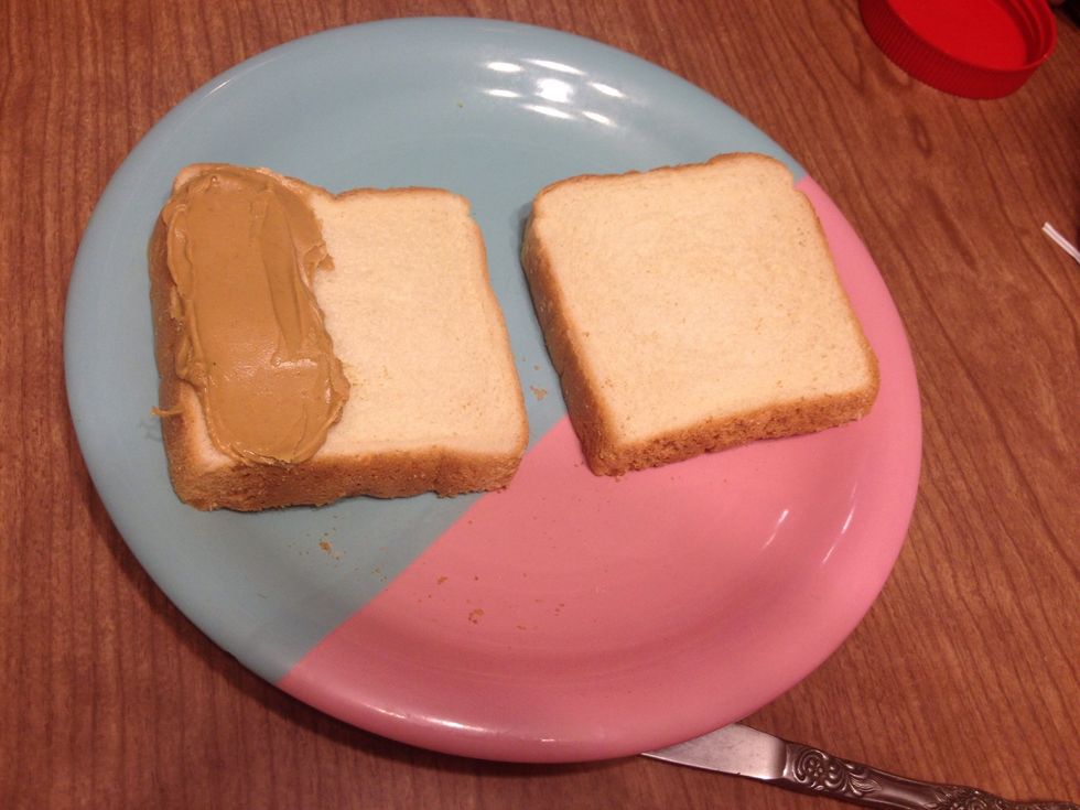 Spread a strip of CREAMY peanut butter vertically on 1 third of the bread.