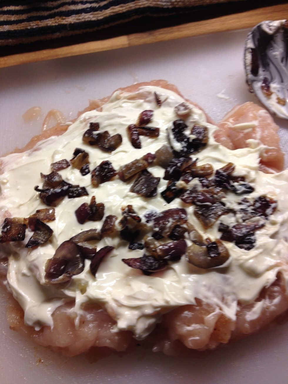 Spread about 2-3 tbsp of cream cheese across the breast, depending on the size and add onions. Use fat free cream cheese for low calorie :). You can also use garlic or chive cream cheese.