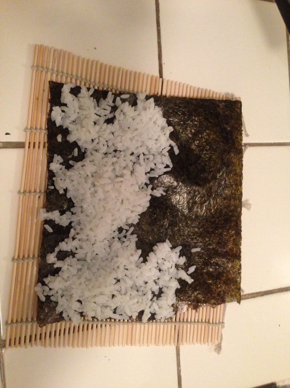 Spread an even layer of rice on top of the entire piece of seaweed. Don't go overboard on the rice, keep in mind you will be putting veggies on top and it has to roll at least one and a half times.