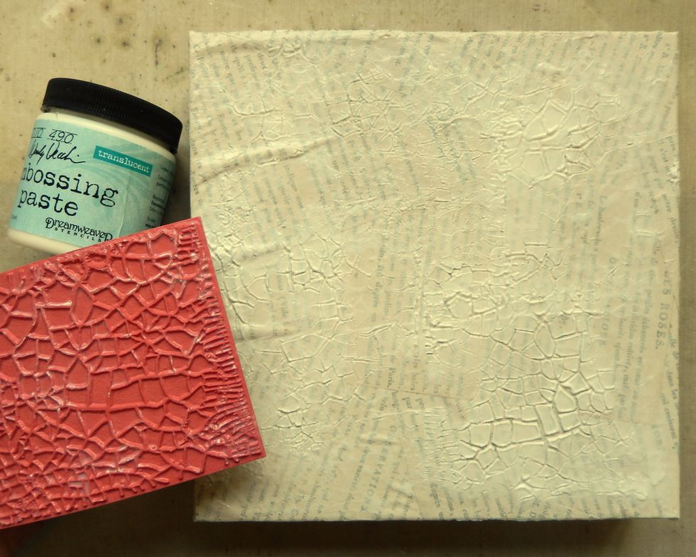 Spread an uneven layer of Translucent Embossing Paste over the canvas. Spray the All Cracked Up stamp with a little water and press into the wet paste. Repeat until the background is covered. Air dry.