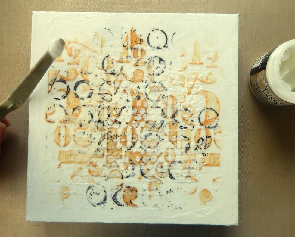Spread an uneven thick layer of Crazing Distress Collage Medium across the whole canvas and allow to dry.