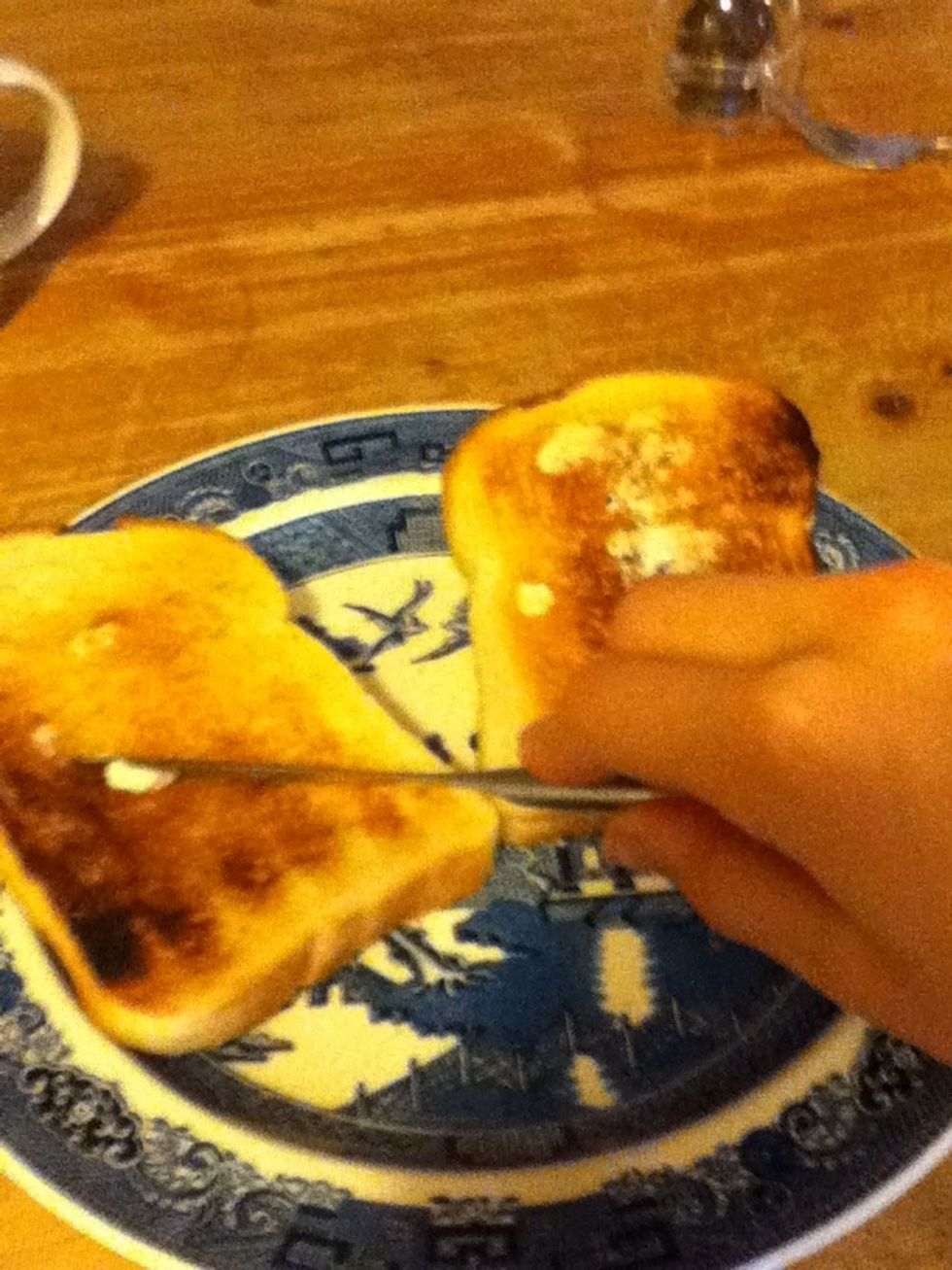 Spread butter on both slices using your knife.