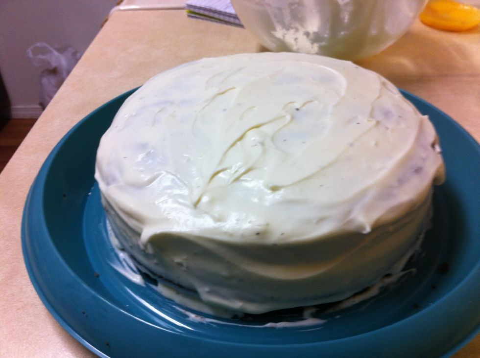 Spread cake with cream and glaze.