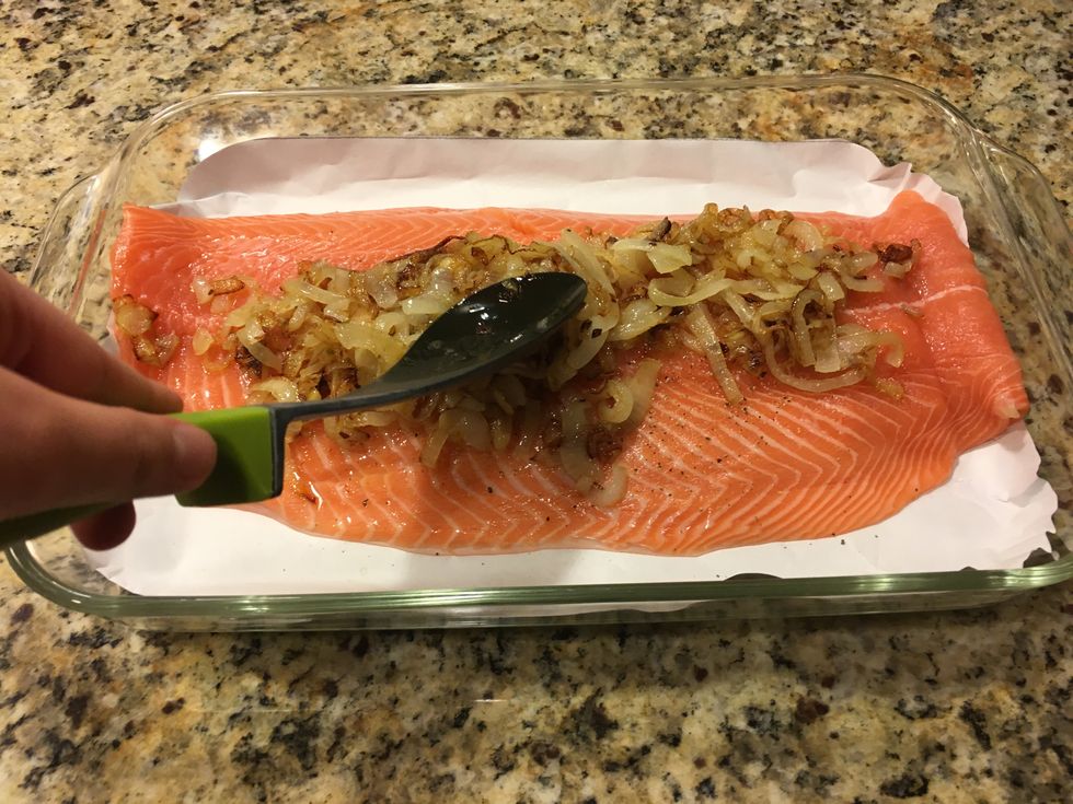 Spread caramelized onions evenly across the top of salmon fillet.