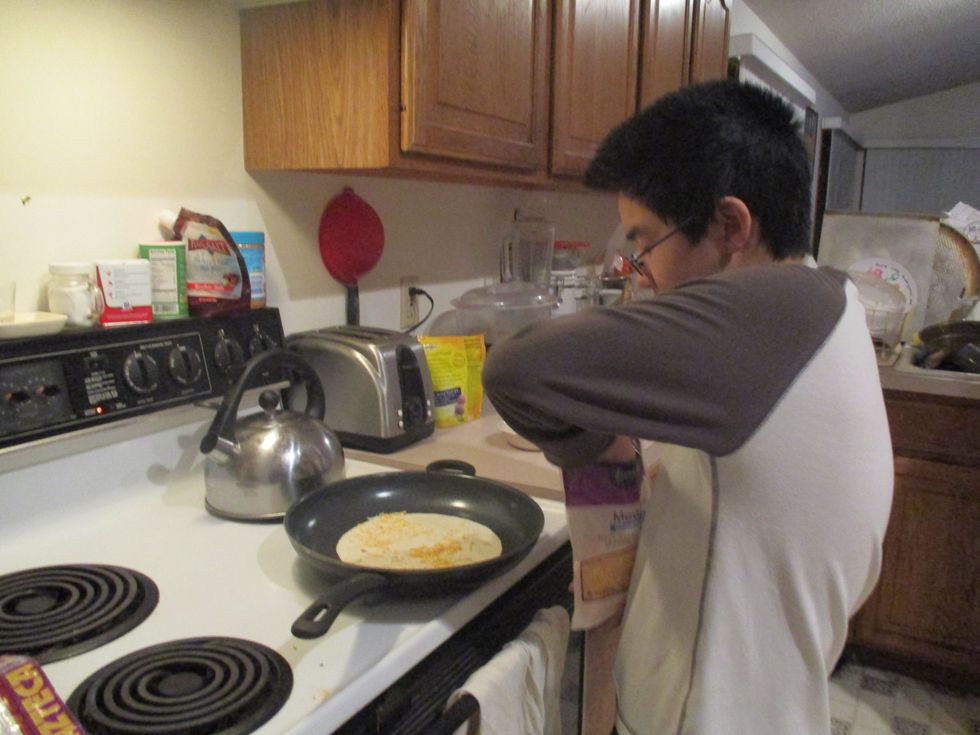 Spread Cheese and Scallions on the whole entire tortilla. see next step to see scallions and cheese.
