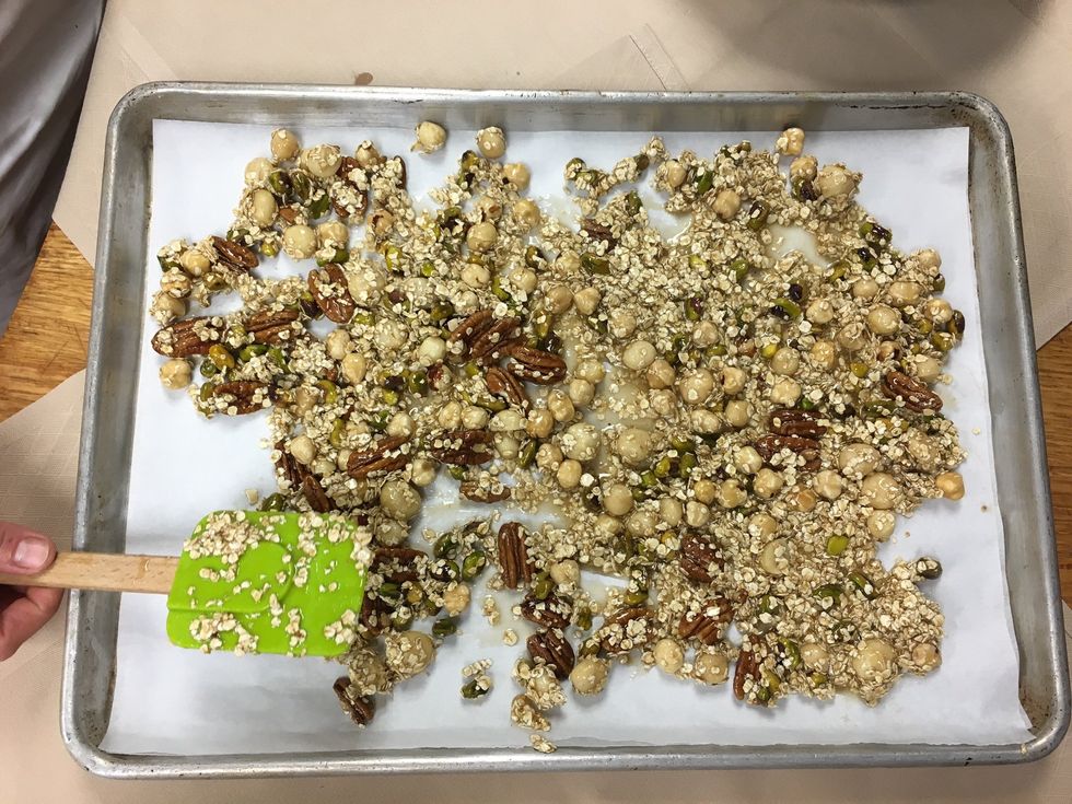 Spread contents of both mixing bowls onto separate 1/2 sheet pans, lined with parchment paper.