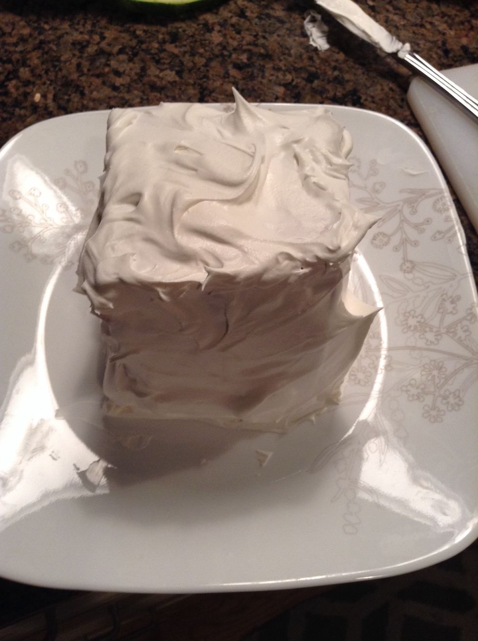 Spread cool whip down the sides of the cube so all the watermelon is covered.