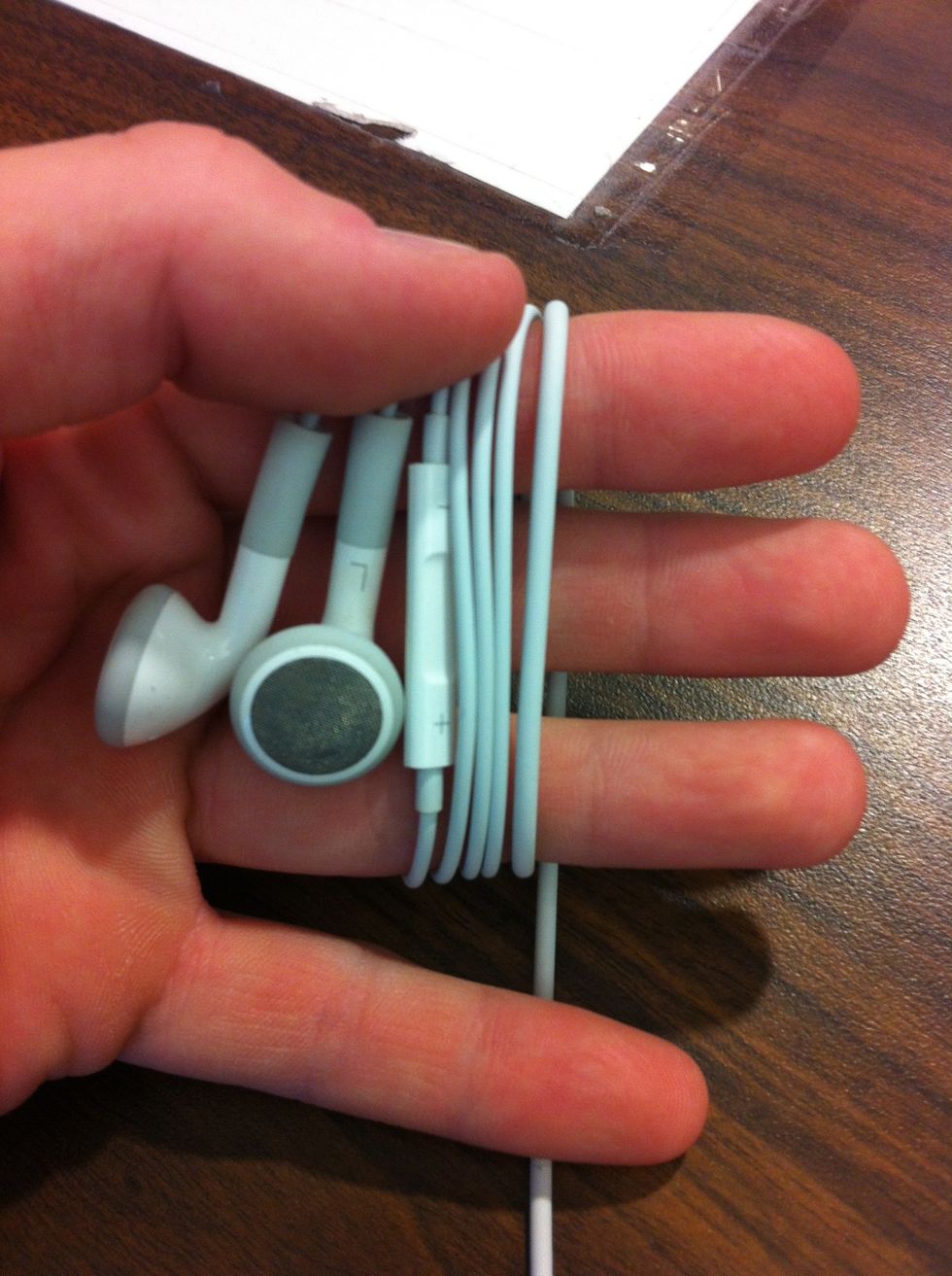 Spread fingers slightly, and continue wrapping cord. (I used 3 fingers to be more compact, but 4 would make for fewer wraps. Less loops = Less tangles!)