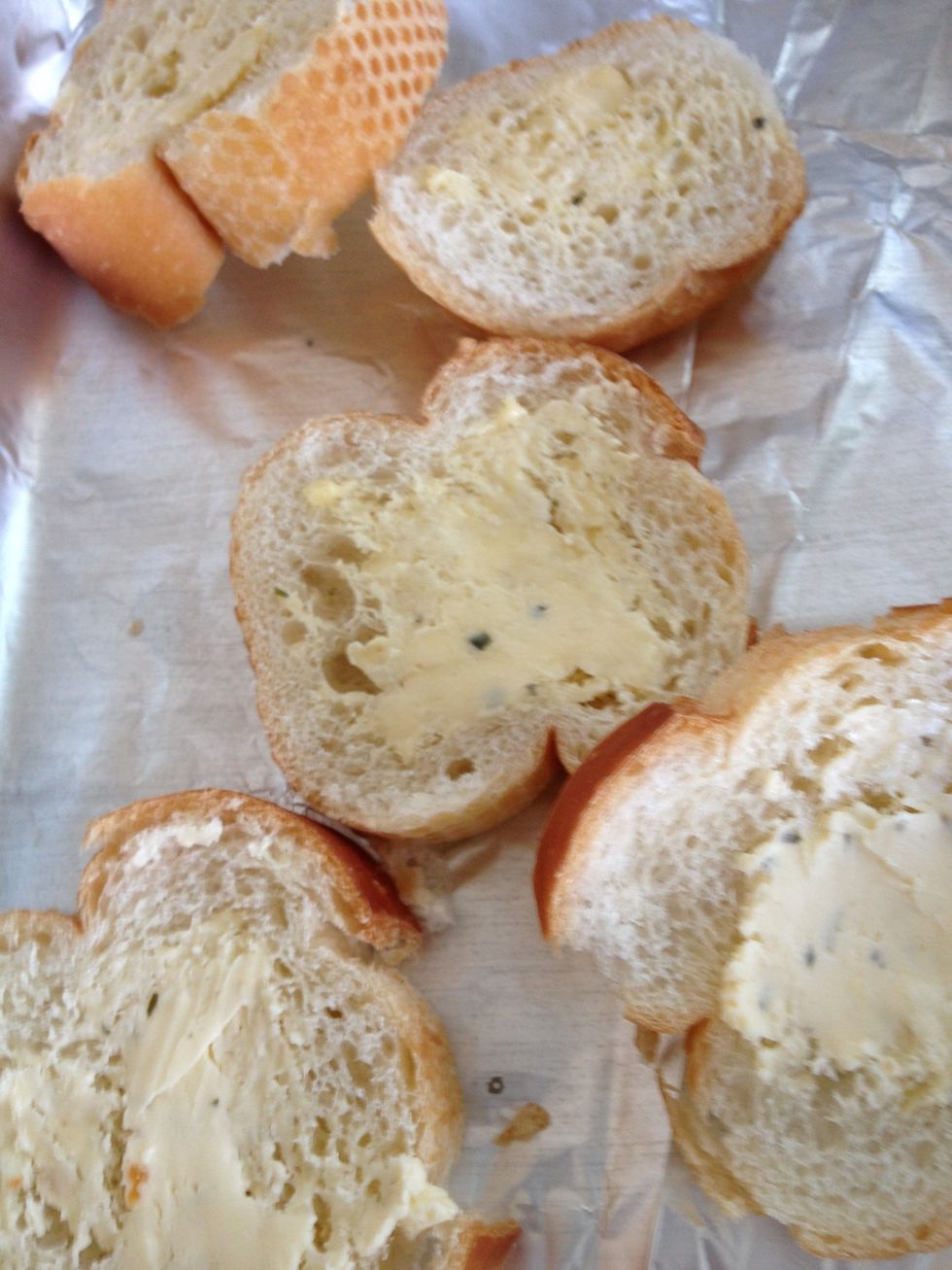 Spread garlic butter on the baguette slices