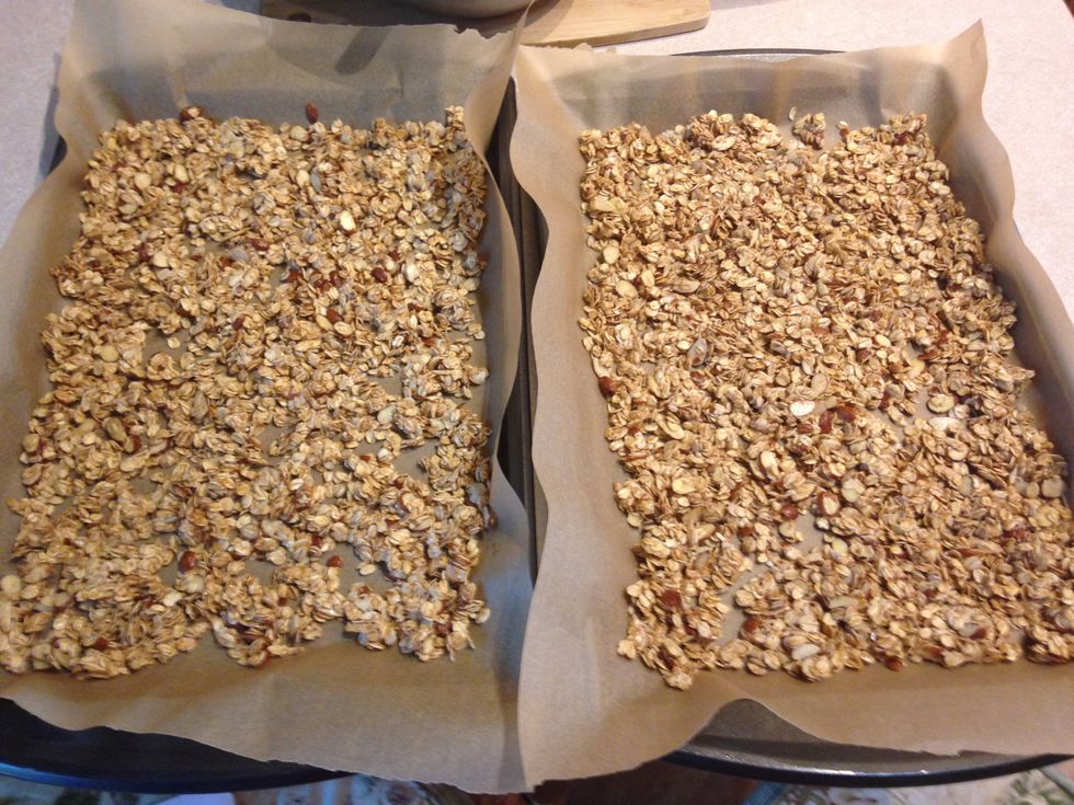 Spread granola out on two sheet trays lined with parchment paper, make sure its pretty even! Bake the trays for 15 minutes.