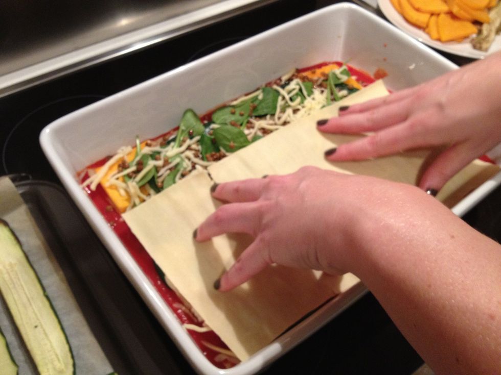 Spread half of the passata on the bottom of the baking dish and place first a layer of lasagna sheet.