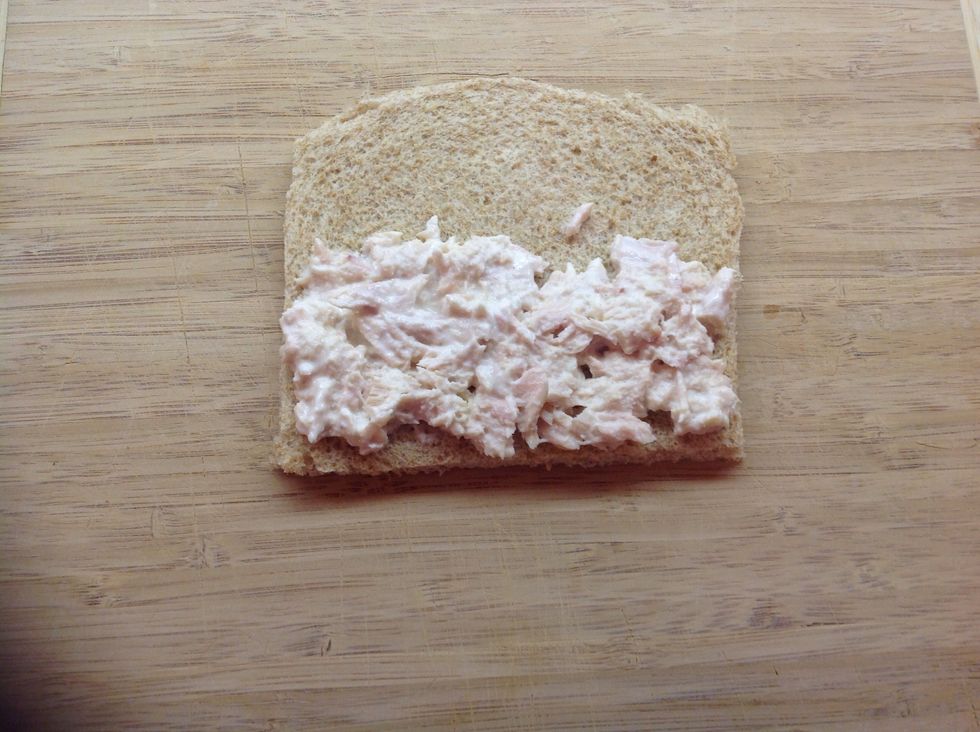 Spread half of the tuna and mayonnaise combo on half of the flattened bread.