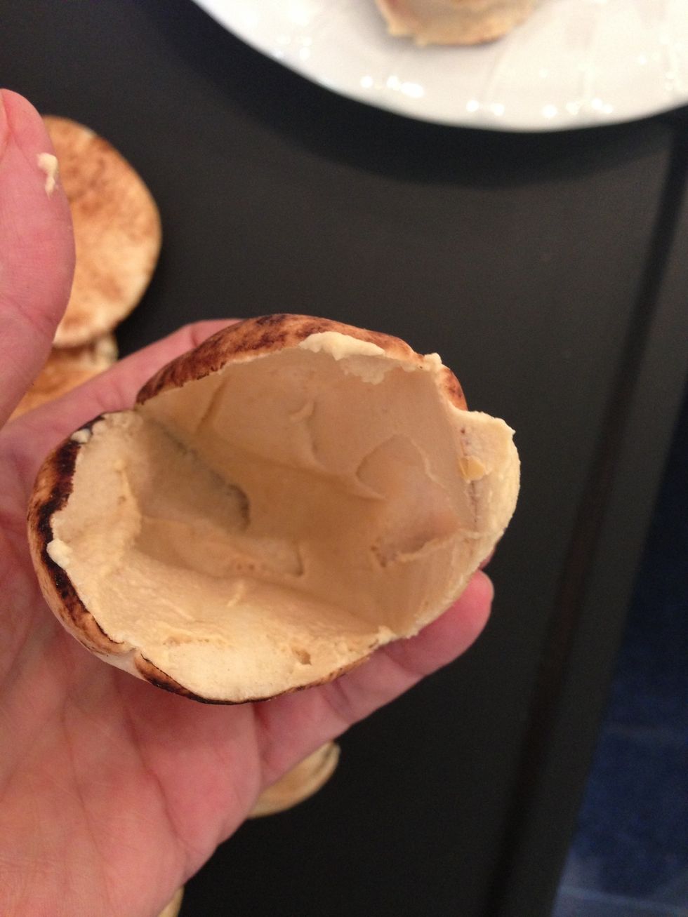 Spread hummus on both sides put the cooked kafta inside like hamburgers. decorate with parsley and serve