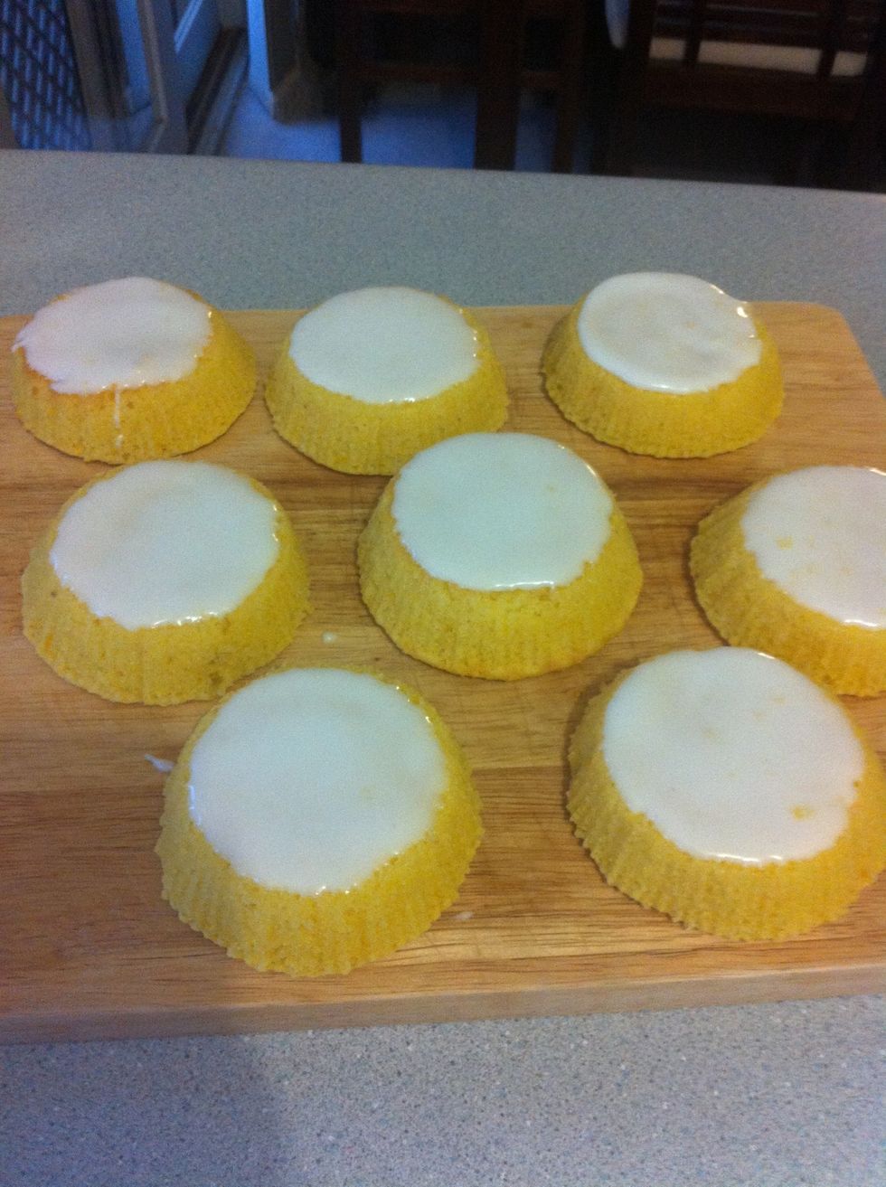 Spread icing over the tops of cakes, this can be as messy or neat as you like.