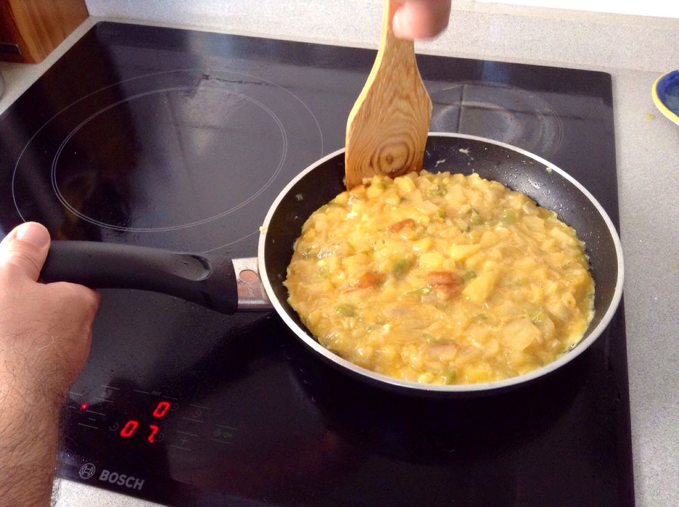 Spread it, filling the frying pan. Draw the edge in with a palette. Cook it until it comes away from the edge of the pan.