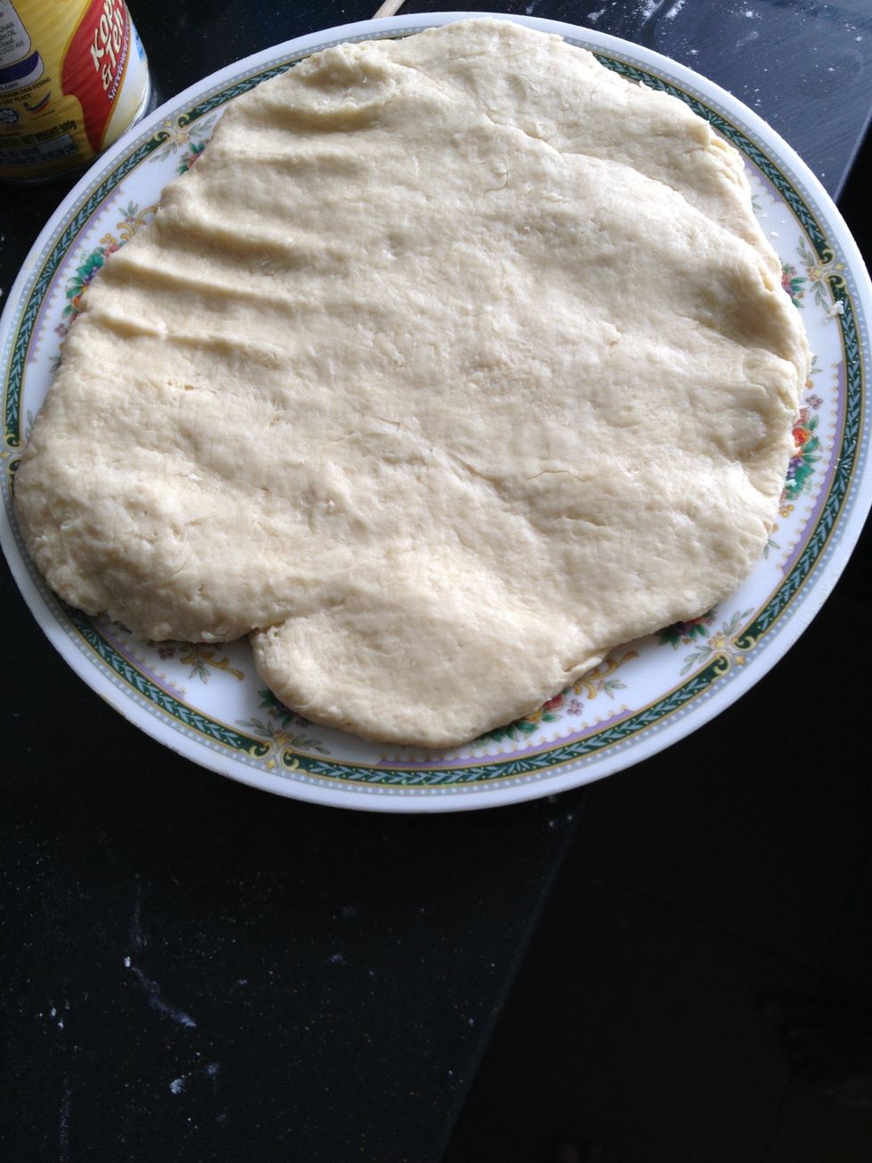 Spread it with hands (or using a rolling pin) to an inch thickness.