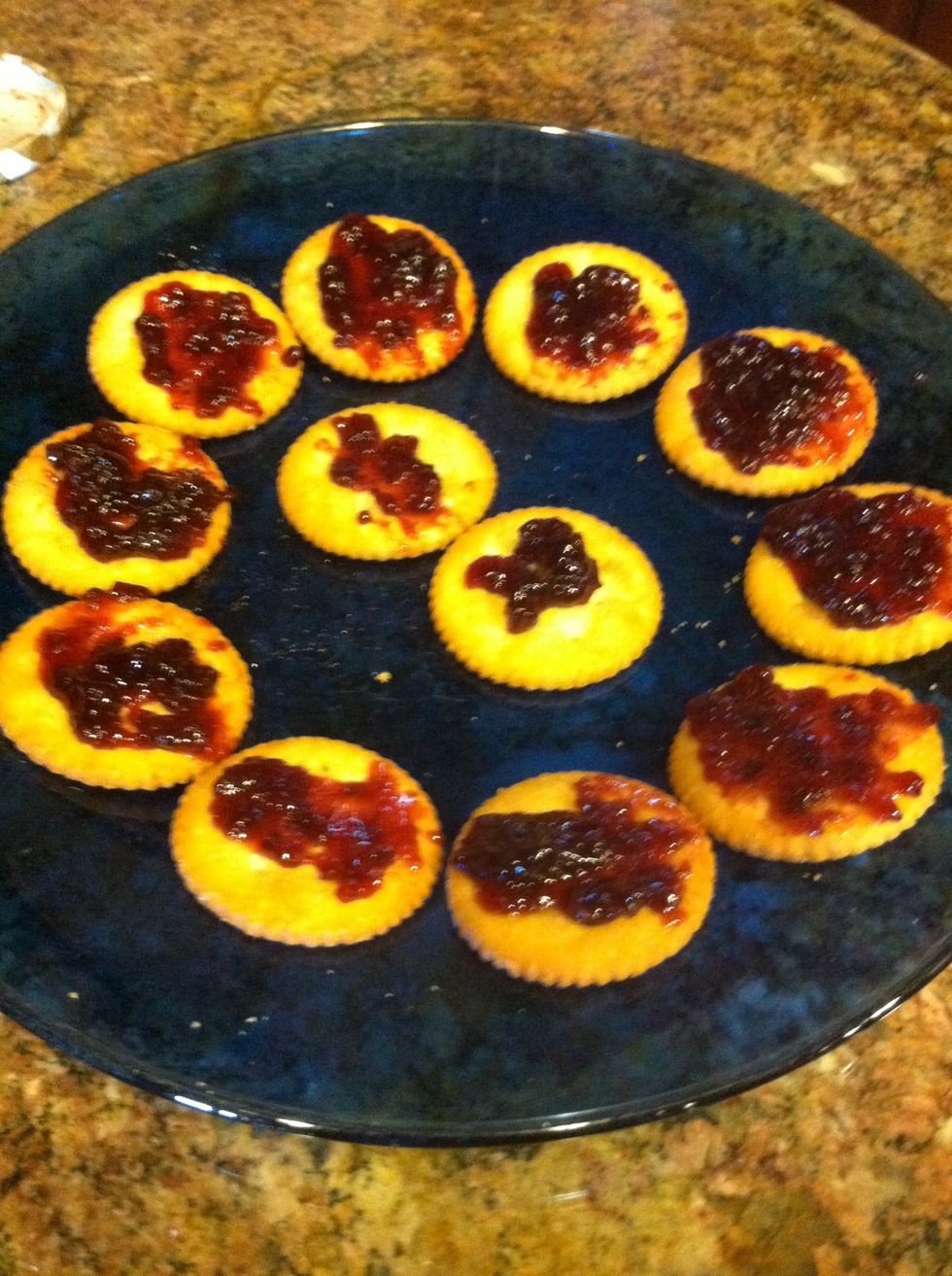 Spread jelly of your choice (I use boysenberry) on the crackers.