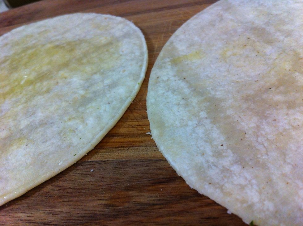 Spread layer of olive oil on tortilla