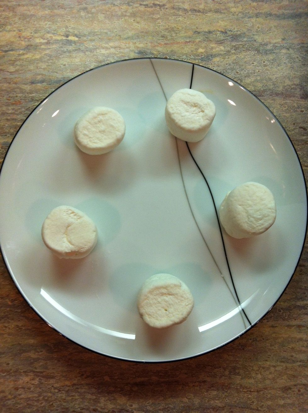 Spread marshmallows out on a plate an inch and a half away from each other