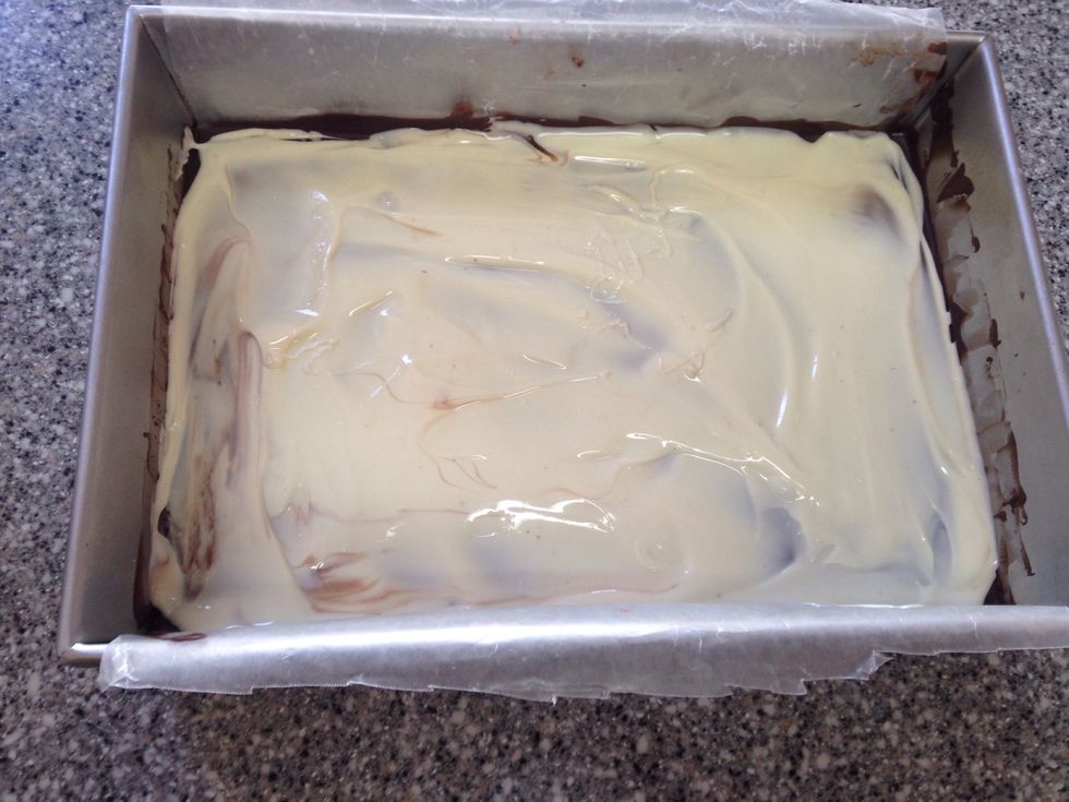 Spread melted white chocolate over frozen dark chocolate, working quickly as the frozen chocolate will start to cool the white chocolate.