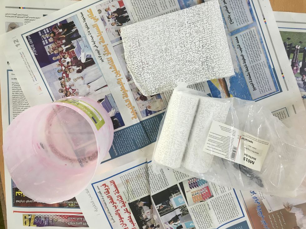 Spread newspaper and place cup of water and plaster on top.