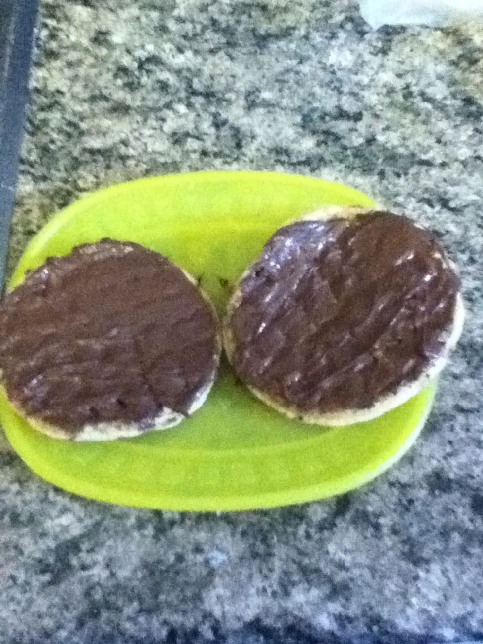 Spread Nutella on both waffles.