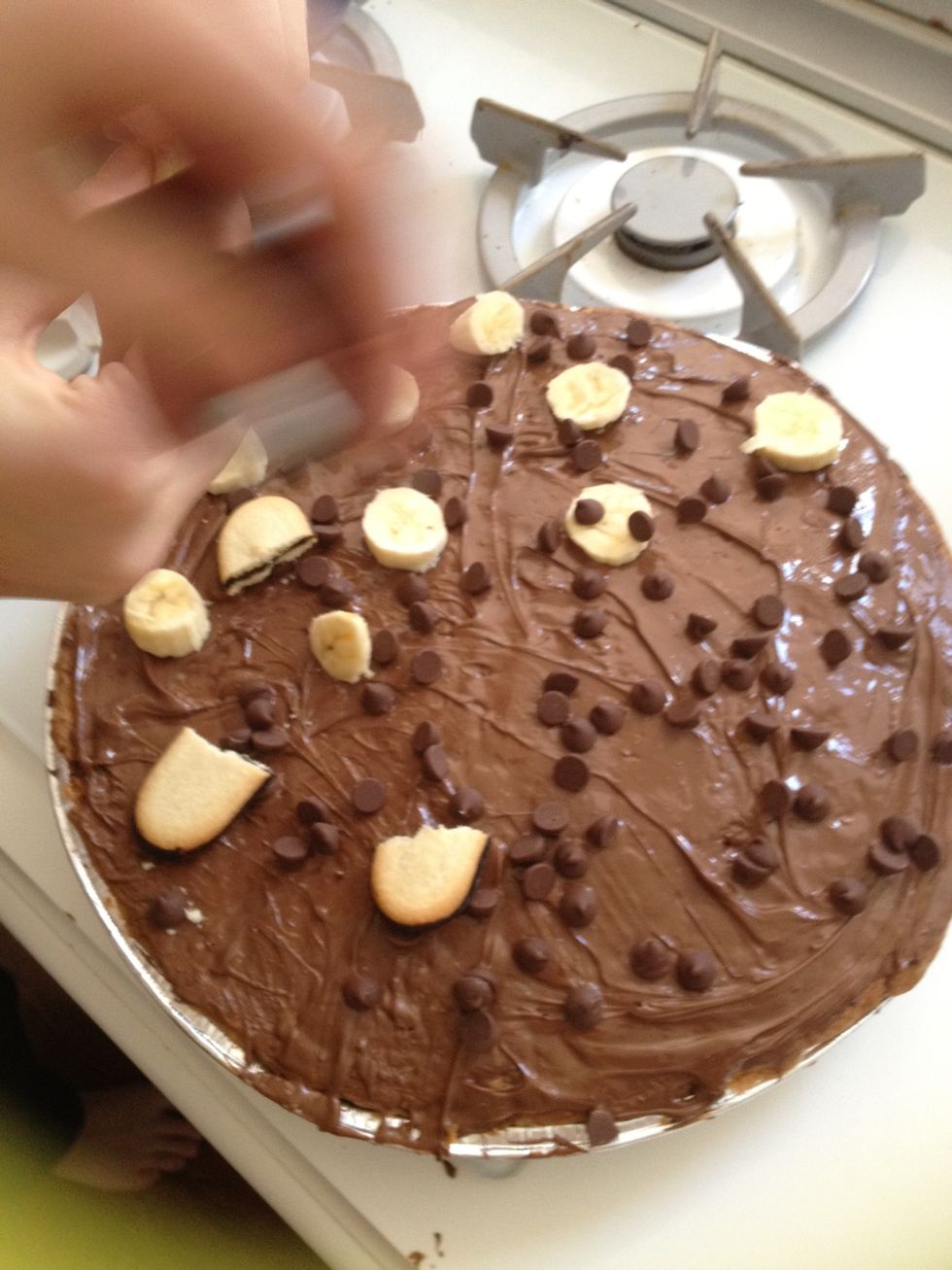 Spread nutella on cookie crust and start adding toppings