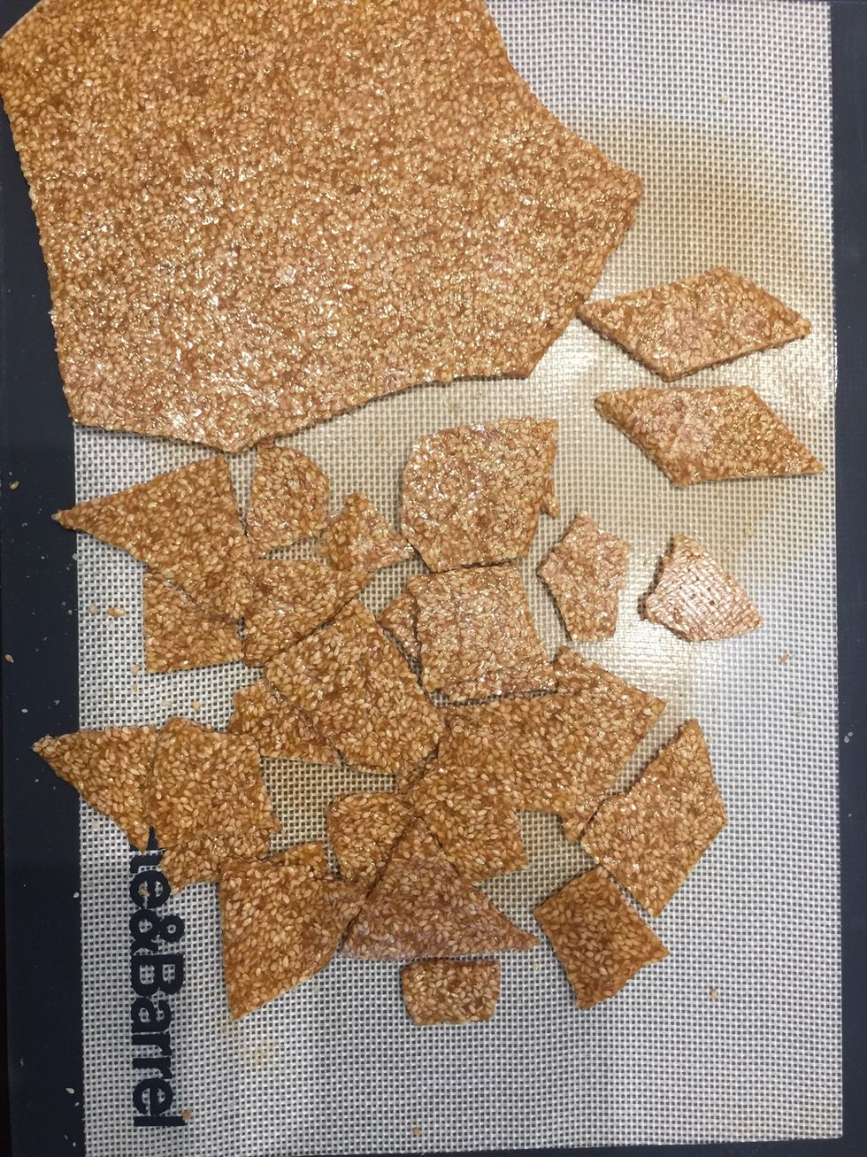 Spread on a heated silpat. When cold break into asymmetrical pieces. Or cut with a knife when it is still hot but touchable